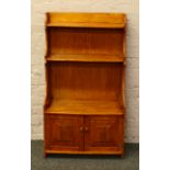 A light oak waterfall bookcase over cupboard base.