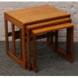 A nest of three teak occasional tables.