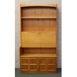 A retro teak open display wall unit incorporating drawer and panelled cupboard with central fitted