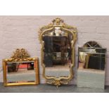 Two gilt framed bevel edge wall mirror adorned with cherubs, along with a ground glass example.