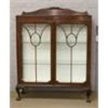 A 1930's mahogany astrigal glazed china cabinet on ball and claw feet. Condition report intended