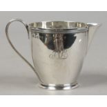 A George III silver cream jug with a reeded band to the rim and loop handle, assayed London 1796,