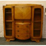 A carved light oak side by side bureau bookcase.