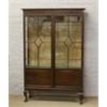 A mahogany astrigal glazed display cabinet raised on cabriole feet.