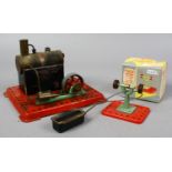 A Mamod steam engine along with a boxed Mamod miniature grinding machine.