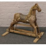 A vintage carved and painted child's rocking horse. Condition report intended as a guide only. Needs