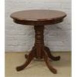 A hardwood circular top centre pedestal table.