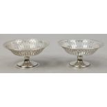 A pair of Edwardian silver pedestal bon bon dishes with pierced rims, assayed Birmingham 1909, 102