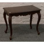 A mahogany occasional table on carved cabriole legs.