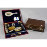 A fitted leather cased vanity set with silver mounted accoutrements by Mappin & Webb assayed
