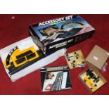 A boxed Scalextric accessory set, along with a boxed lap counter and four F1 cars.