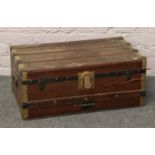 A wood and metal bound travel trunk.