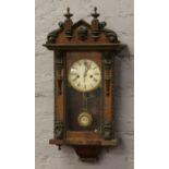 An early 20th century walnut cased musical wall clock.