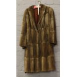 A ladies vintage full length fur coat.