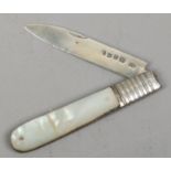 A Georgian silver folding fruit knife with mother of pearl scales.