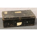 An ebonized tin travel trunk.