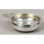 A white metal porringer stamped international sterling.