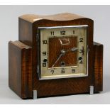 An  oak Westminster chime mantle clock with pendulum and key.