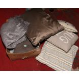 A box of modern textile throws and cushions, 8 pieces.