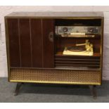 A vintage Grundig Balmoral 7070 3D radiogram with Collaro turntable and built in vinyl record rack.