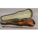 A 19th century violin and bow in case. No makers marks to either, 35.75cm.