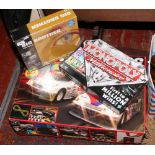 A Tourers 200 Scalextric set along with a Monopoly millionaire board game and Big Brother game.