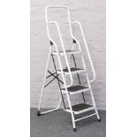 A set of folding steel step ladders.