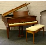 A mahogany baby grand piano raised on square tapering supports, Hopkinson London, along with a