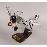 A Nieuport 17C 1/20 scale model bi plane raised on wooden stand.