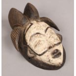 A West African, South Gabon, carved tribal wood Punu mask. Highlighted with kaolin pigment and