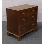 A Georgian oak bachelors chest of drawers, cross banded with strung inlay and raised on bracket