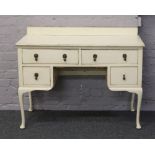 A shabby chic Queen Anne style ladies dressing table, cream painted and raised on cabriole