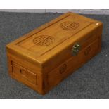 An oriental camphor wood storage box with brass metal mounts.