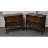 Two matching carved oak chests of two drawers raised on barleytwist supports.