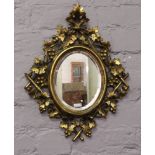 A bevel edge wall mirror with gilt carved wood frame formed as grape vines.