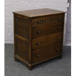 A Priory style carved oak chest of four drawers.