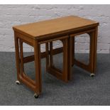 A McIntosh teak nest of three tables with fold over top.