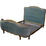 A French bed frame upholstered in teal velvet with brass stud work.