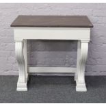 A painted console table raised on reeded scroll supports.