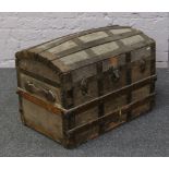 A metal bound wood travel trunk with fitted interior top.