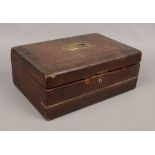 A 19th century tooled leather covered writing slope with fitted interior and brass metal mounts,