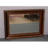 A large mahogany framed bevel edge mirror.