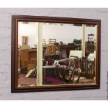 A large mahogany framed bevel edge mirror.