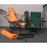 Three folding camping chairs along with two similar stools.