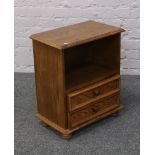 A carved oak two drawer side cabinet.