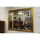 A large gilt framed bevel edge wall mirror, 94cm x 120cm.