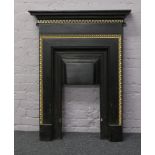 A cast iron bedroom fire surround with gilt decoration 122cm x 91cm.