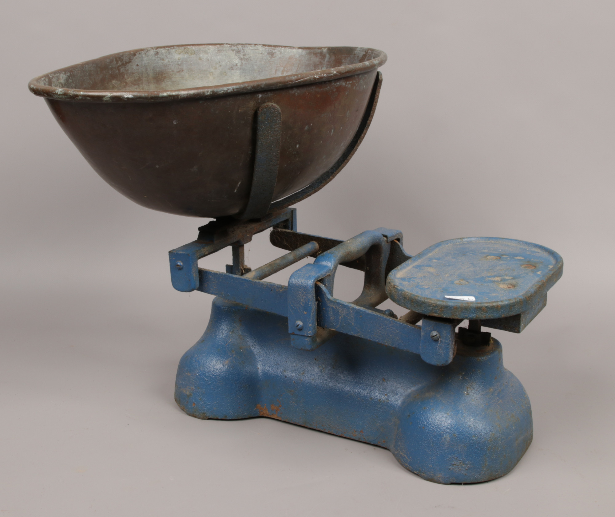 A painted pair of cast iron shop scales.