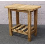 A pine butchers block with slatted under tier, raised on square cut legs.