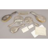 Six silver mounted hand mirrors and brushes.Condition report intended as a guide only.Some damage.